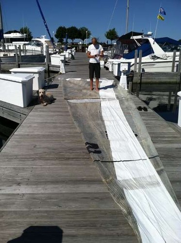 Repairing the headsail. Sometimes you can buy almost-new sails from racing sailors who have used them for only one racing season ©  SW
